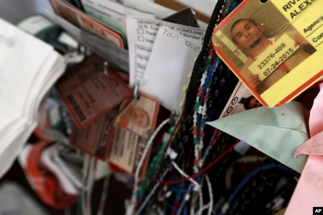 FILE - Dozens of deportee bracelets hang from a cross inside a migrant shelter in Ciudad Juarez, Mexico, Nov. 14, 2016.