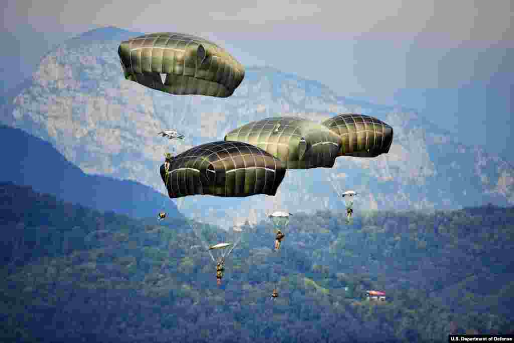 Paratroopers from 173rd Brigade Support Battalion, 173rd Airborne Brigade land after a jump at Juliet Drop Zone in Pordenone, Italy. The U.S. Army paratroopers conducting an airborne operation with T-11 parachutes from C-130 Hercules Aircraft of the 86th Airlift Wing are stationed at Ramstein Air Base, Germany. (U.S. Army photo by Visual Information Specialist Davide Dalla Massara) 