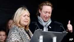 Cynthia Lennon and her son, Julian, appear at the unveiling of a European peace monument dedicated to the memory her former husband and his father, John Lennon, in Chavasse Park, Liverpool, England, Oct. 9, 2010.