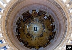 FILE - Visitors pay their respects as the casket of Reverend Billy Graham lies in honor at the Rotunda of the U.S. Capitol Building in Washington, Feb. 28, 2018.