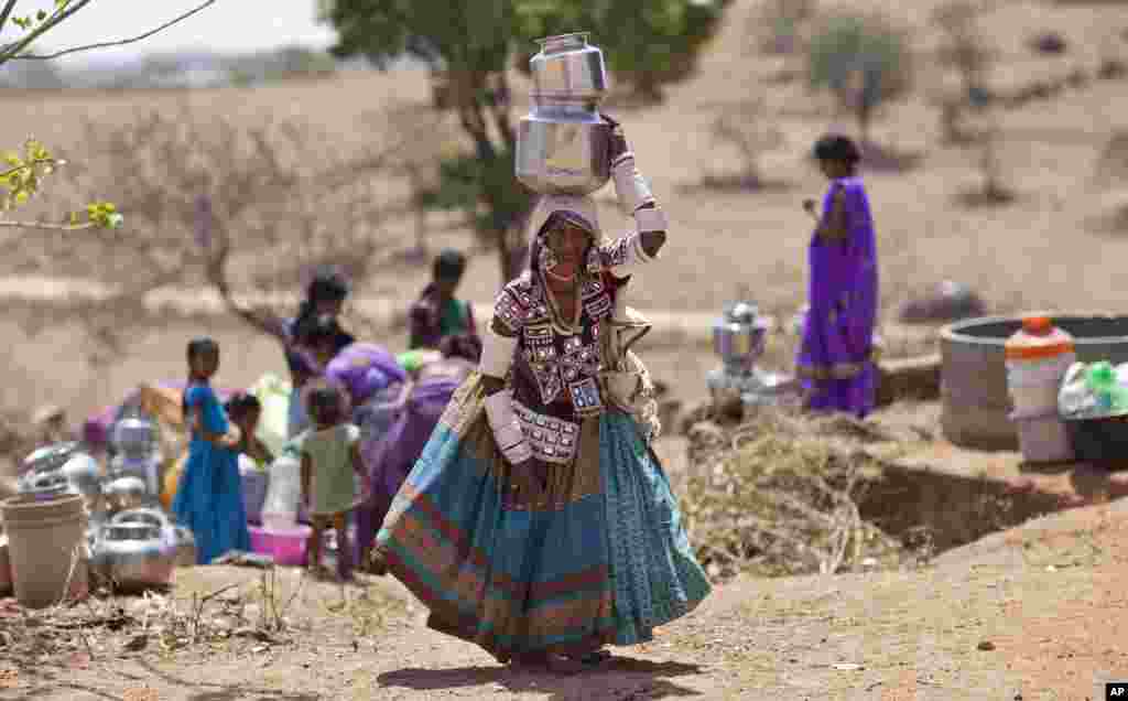 An indigenous woman collects water from public tap on the eve of World Water Day, outskirts of Hyderabad, India, March 21, 2017.