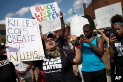 Protestors rally during a Black Lives Matter demonstration, July 10, 2016, in Cincinnati. More than a thousand protested against the shootings of black men by police officers.
