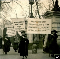 FILE - In this circa 1918 photo women demonstrate at the White House in Washington demanding voting rights.