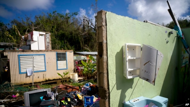 In this Saturday, Oct. 14, 2017 photo, what was once the home Arden Dragoni and his family lays in ruins after the passing of Hurricane Maria in Toa Baja, Puerto Rico. (AP Photo/Ramon Espinosa)