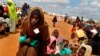 FILE - Somali refugees walk through an area housing new arrivals, on the outskirts of Hagadera Camp outside Dadaab, Kenya, Aug. 5, 2011. Residents of a new "integrated" settlement at Kalobeyei, in the country's northeast, complain that living conditions are not as they expected them to be.