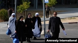 FILE - Catholic nuns and a priest arrive on the Israeli side of the Erez Crossing, after leaving the Gaza Strip.