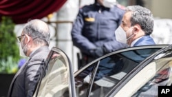 Political deputy at the Ministry of Foreign Affairs of Iran, Abbas Araghchi, right, arrives at the Grand Hotel Wien where closed-door nuclear talks with Iran take place in Vienna, Austria, Tuesday, April 6, 2021. (AP Photo/Florian Schroetter)