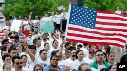 People participate in 'A Day Without Immigrants' rally, May 1, 2006 at the Civic Center Plaza in Tulsa, Okla., where according to the U.S. Census Bureau, Tulsa had a 97 percent increase in Hispanic population from 2000 to 2010, while the suburb of Owasso 
