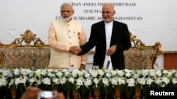 India's Prime Minister Narendra Modi (left) and Afghanistan's president Ashraf Ghani shake hands during the inauguration of the Salma Dam in Herat province, Afghanistan, June 4, 2016.