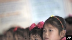 North Korean orphans during a visit from a foreign delegation at their orphanage in the area damaged by recent floods and typhoons in North Hwanghae province September 29, 2011.