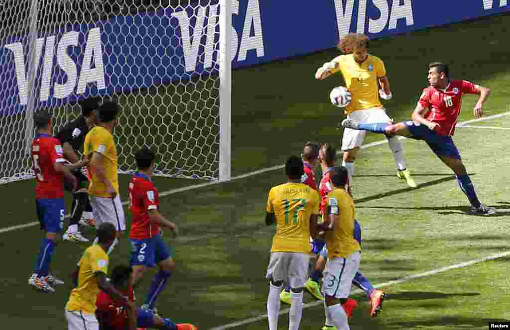 Brazil's David Luiz scores against Chile at the Mineirao stadium in Belo Horizonte, June 28, 2014.