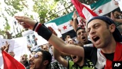 Demonstrators chant slogans during a protest demanding the ouster of the Syrian government, in front of the Syrian embassy in Cairo April 26, 2011