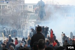 Police begin using tear gas on protesters near the Skanderbeg Monument in Pristina, Jan. 9, 2016. (P.W. Wellman/VOA)