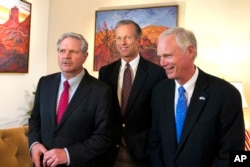 U.S. Sen. John Hoeven, R-N.D., left, Sen. John Thune, R-S.D., center, and Sen. Jerry Moran, R-Kan., chairman of the Subcommittee on Consumer Protection, Product Safety, Insurance, and Data Security, speak to the Associated Press in the U.S. Embassy in Moscow, July 4, 2018.
