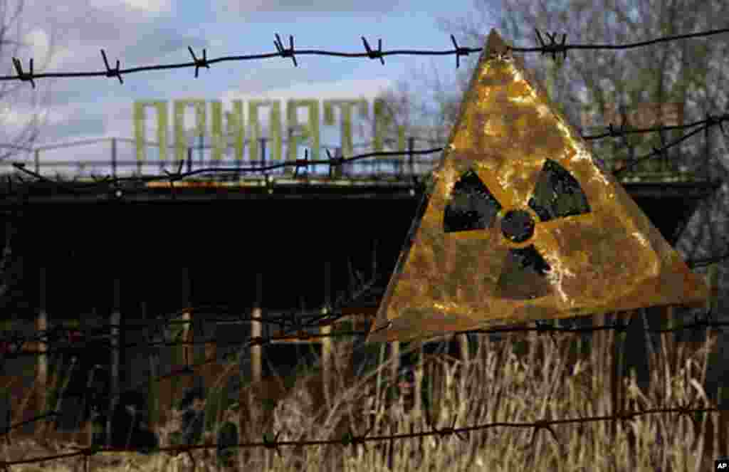 A radioactive sign hangs on barbed wire outside a café in Pripyat. (VOA Photo/D. Markosian)