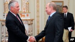 Vladimir Putin, at the time Russian Prime Minister, meets with Rex W. Tillerson, chairman and chief executive officer of Exxon Mobil Corporation.