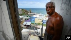 La Perla resident Ramon Marrero, 76, stands in his battered residence after Hurricane Maria, in San Juan, Puerto Rico, Sept. 25, 2017. 