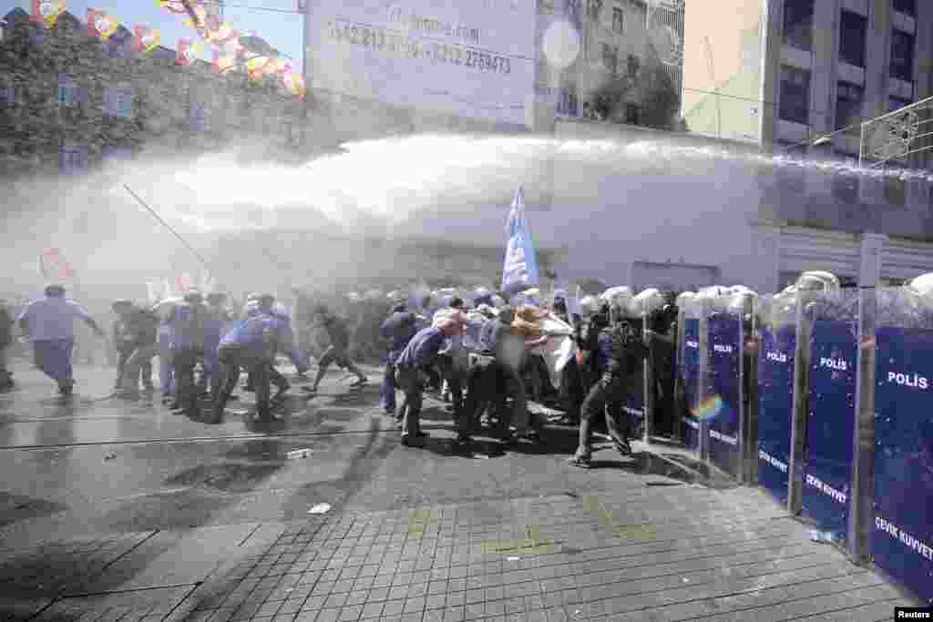 Riot police use a water cannon to disperse anti-government protesters during a demonstration in Istanbul, Turkey.