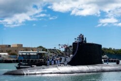 In this photo provided by U.S. Navy, the Virginia-class fast-attack submarine USS Illinois (SSN 786) returns home to Joint Base Pearl Harbor-Hickam from a deployment in the 7th Fleet area of responsibility on Sept. 13, 2021.