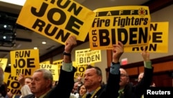 Supporters hold signs as former Vice President Joe Biden addresses the International Association of Fire Fighters in Washington, March 12, 2019.