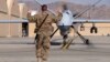 A U.S. airman guides a U.S. Air Force MQ-9 Reaper drone as it taxis to the runway at Kandahar Airfield, Afghanistan, March 9, 2016. 