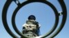 FILE - An anti-personnel mine detecting worker stands at a mine field near Vilancoulos in southern Mozambique, 450 km (265 miles) north east of Maputo, Nov. 2004 file photo. 