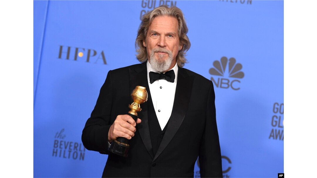 FILE - Jeff Bridges poses in the press room with the Cecil B. DeMille award at the 76th annual Golden Globe Awards in Beverly Hills, Calif., Jan. 6, 2019.