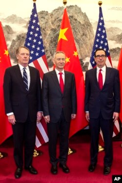 China's Vice Premier Liu He, center, poses for a photo with U.S. Treasury Secretary Steven Mnuchin, right, and U.S. Trade Representative Robert Lighthizer at Diaoyutai State Guesthouse in Beijing, March 29, 2019.