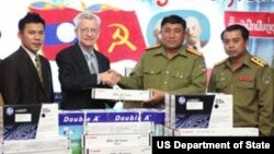 Mr. Lacy Wright, Director of the Law Enforcement and Narcotics Section at the U.S. Embassy gives office supplies to Colonel Khamphonh Sihapanya, Director of the Lao Drug Police.