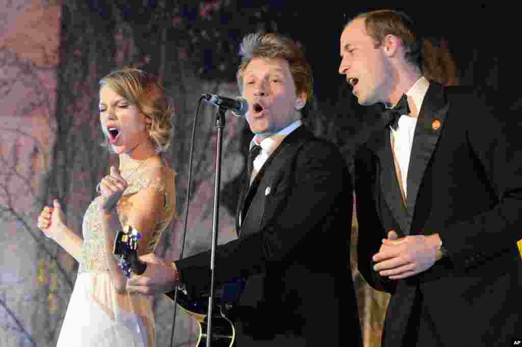 Britain's Prince William, the Duke of Cambridge, right, sings with US singers Taylor Swift, left, and Jon Bon Jovi at the Centrepoint Gala Dinner at Kensington Palace in London, Nov. 26, 2013.