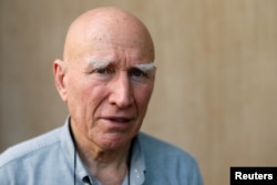 Brazilian photographer Sebastiao Salgado poses for a portrait after an interview with Reuters in Bangkok, Thailand, Feb. 9, 2017.