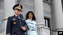 South Carolina Gov. Nikki Haley, seen in this Jan. 14, 2015 file photo, is escorted down the steps of the Capitol by her husband Michael, in Columbia, S.C. President-elect Donald Trump has chosen Haley as U.S. ambassador to the United Nations, the first woman tapped for a top-level administration post during his White House transition so far.