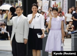 Japan's Crown Prince Naruhito, from left, his wife Crown Princess Masako and their daughter Princess Aiko wave as they arrive at a train station in Matsumoto, Nagano Prefecture, Japan, Aug. 10, 2016.