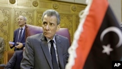 FILE - Libyan representative Ashour Abu-Rashed attends an emergency meeting to discuss the conflict in Libya, at the Arab League headquarters in Cairo, Jan. 5, 2015. 