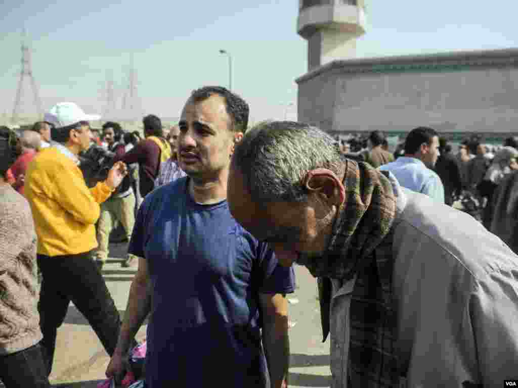 Yasser Awad in blue is seen crying with his father after getting released from Tora prison under a presidential pardon. “I still have three other brothers in jail,” he said in Cairo, Egypt, Tuesday, March 14, 2017. (H. Elrasam/VOA)