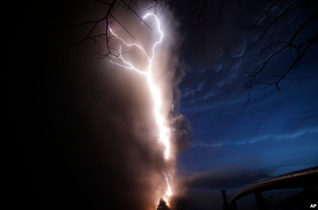 Lightning flashes as Taal Volcano erupts Sunday Jan. 12, 2020, in Tagaytay, Cavite province, outside Manila, Philippines.