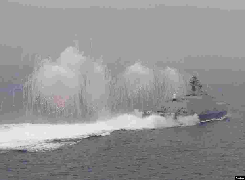 Flares are set off from a Taiwan navy missile ship in a military drill outside a naval base in Kaohsiung port, southern Taiwan.