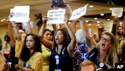 Protesters yell as DNC Chairwoman, Debbie Wasserman Schultz, D-Fla., arrives for a Florida delegation breakfast, Monday, July 25, 2016, in Philadelphia, during the first day of the Democratic National Convention. (AP Photo/Matt Slocum)