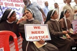 Catholic nuns hold placards demanding the arrest of a bishop who one nun has accused of rape, during a public protest in Kochi, Kerala, India, Sept. 12, 2018.