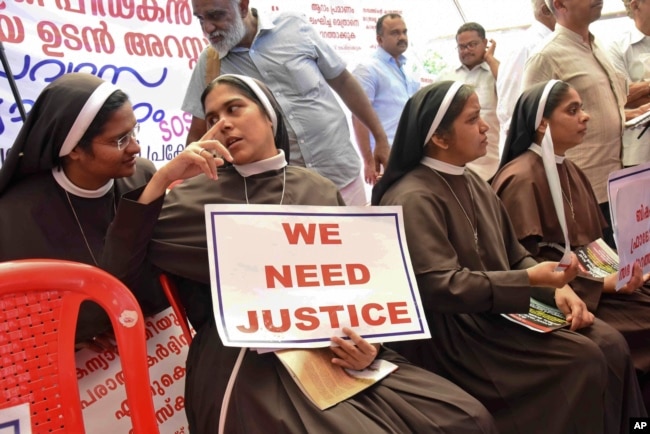 Catholic nuns hold placards demanding the arrest of a bishop who one nun has accused of rape, during a public protest in Kochi, Kerala, India, Sept. 12, 2018.