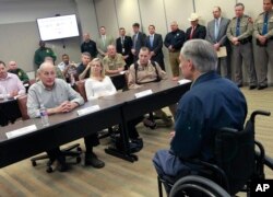 Secretary of Homeland Security John Kelly, left, talks with Texas Governor Greg Abbott, right