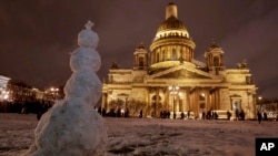 FILE - A snowman stands in front of the St. Isaac's Cathedral in St. Petersburg, Russia, Jan. 13, 2017. The Hermitage Museum Director Mikhail Piotrovsky has urged the head of the Russian Orthodox Church to recall its bid for control of the landmark.
