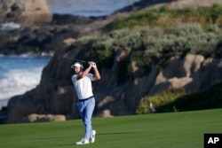 Luke Donald, of England, hits from the fairway on the 10th hole during a practice round for the U.S. Open Championship golf tournament Wednesday, June 12, 2019, in Pebble Beach, Calif. (AP Photo/Matt York)