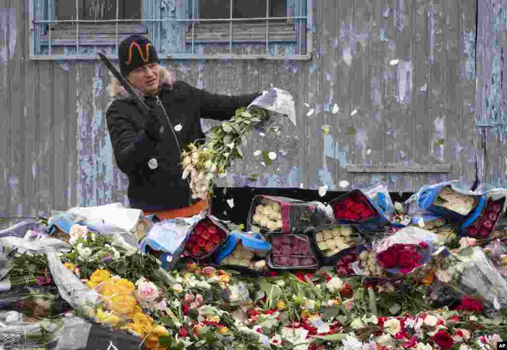 A flower shop employee cuts up unsold flowers in St. Petersburg, Russia.