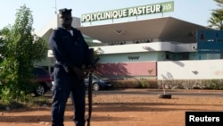 A police officer stands guard outside the quarantined Pasteur Clinic in , Nov. 12, 2014. The government of Mali confirmed the country's second case of Ebola late on Tuesday and police were deployed outside the clinic in the capital, Bamako, that authorities said had been quarantined.