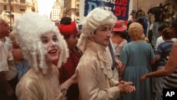 Oo la la! Three members of Le Studio Dramatique, a French acting group, participate in Bastille Day celebrations on 60th Street in New York City in 1997. (AP Photo/Suzanne Plunkett)