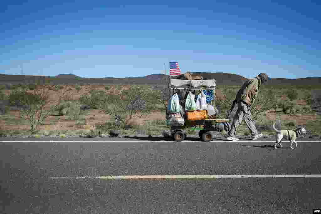 Self-proclaimed nomad Chris Kirkland walks along Country Road B002 while on a cross-country hike outside Columbus, New Mexico, near the U.S.-Mexico border, Feb. 19, 2017.