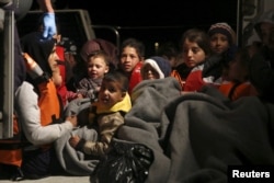 Refugee children are seen onboard a Greek Coast Guard vessel, carrying other refugees and migrants, as it arrives at the port of Mytilene on the Greek island of Lesbos, following a rescue operation at open sea, April 5, 2016.