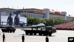 FILE - Military vehicles carry drones during a parade commemorating the 70th anniversary of Japan's surrender during World War II held in front of Tiananmen Gate in Beijing, Sept. 3, 2015.