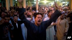 Coptic Christians shout slogans during a funeral service for victims of a bus attack, at Abu Garnous Cathedral in Minya, Egypt, May 26, 2017.